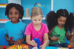 Image of three children doing craft activities