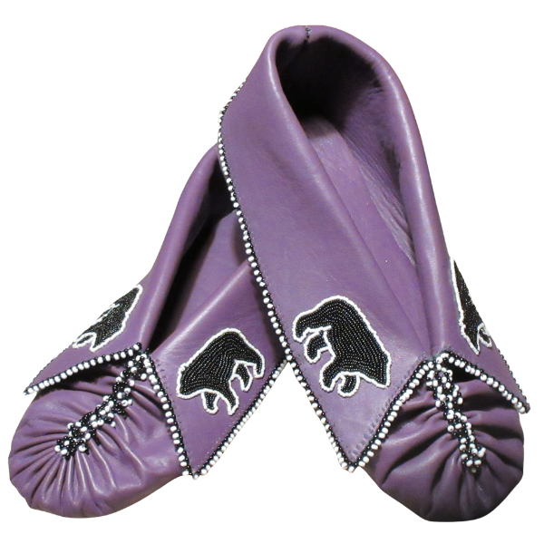 A pair of purple moccasins decorated with black bear designs and white bead accents along the edges and around the toe area.